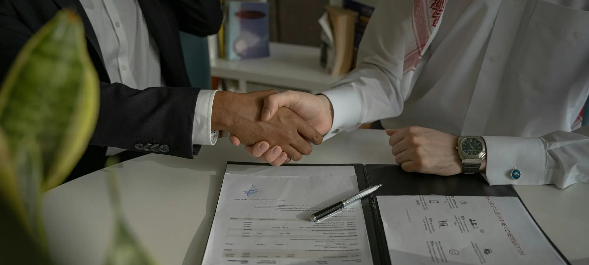 Buyer and supplier shaking hands over a contract